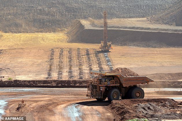 28645592-8346159-A_haulage_truck_and_an_autonomous_drilling_rig_at_the_Rio_Tinto_-a-25_1590111244710.jpg,0