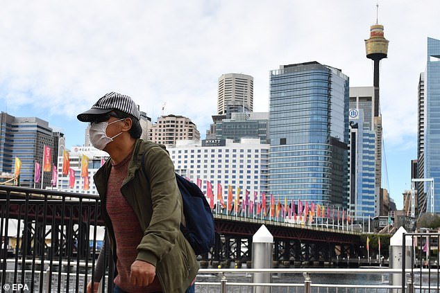 31757566-8610373-A_pedestrian_wearing_a_face_mask_walks_at_Darling_Harbour_in_Syd-a-1_1597026308740.jpg,0