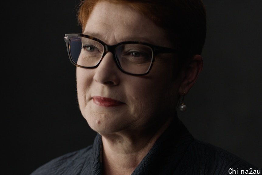 A portrait of a women in black wearing glasses, glancing to her right