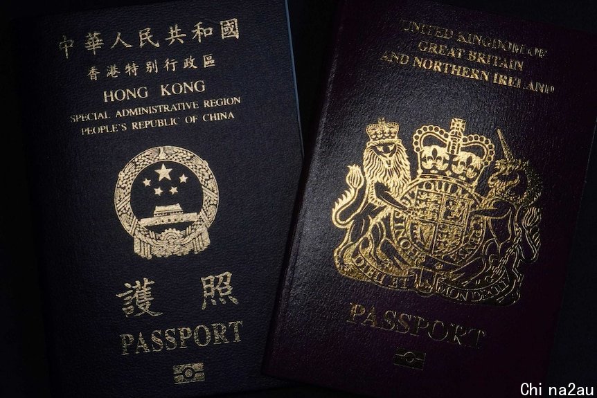 A Hong Kong passport sits alongside a UK passport with a black background.