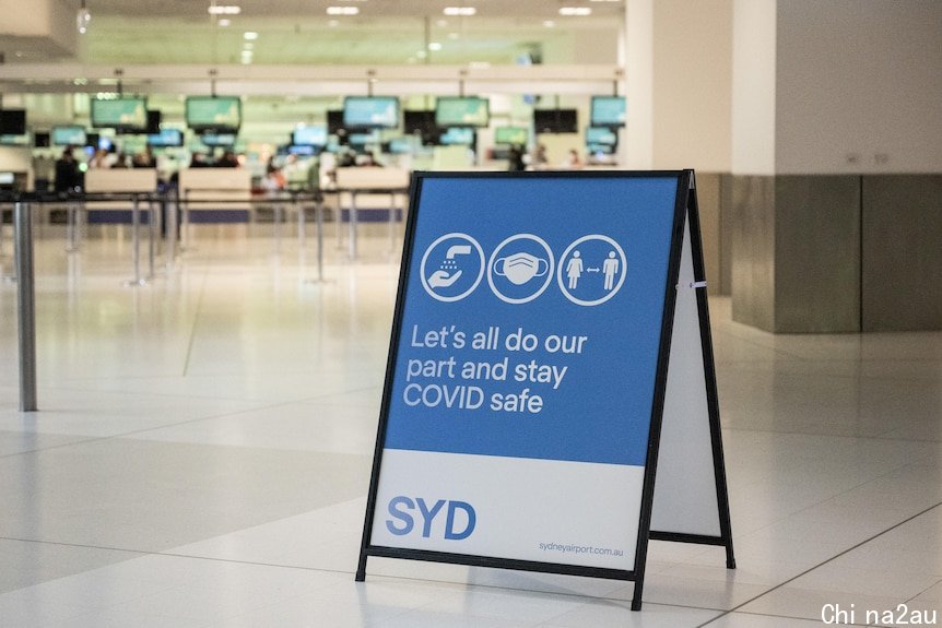 a signage about covid safe procedures in the middle an empty airport