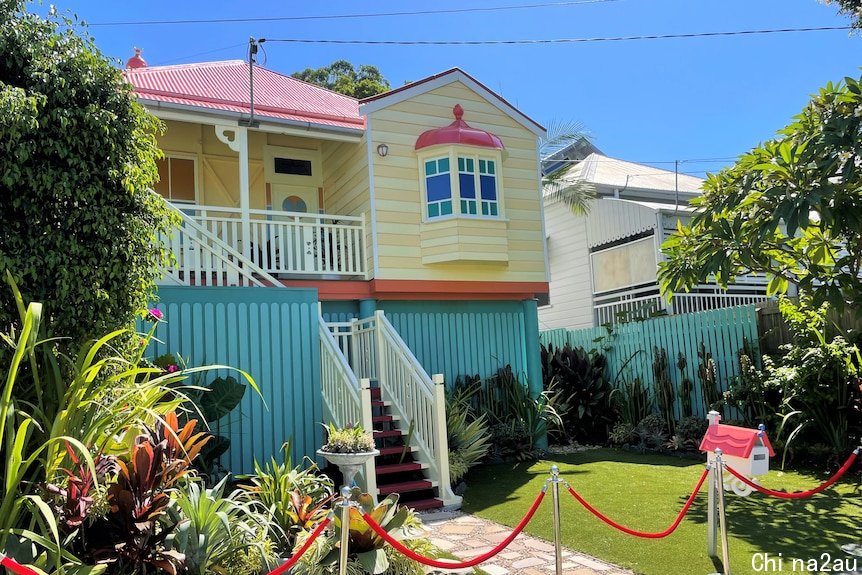 A small yellow and red cottage made to look like the Bluey house