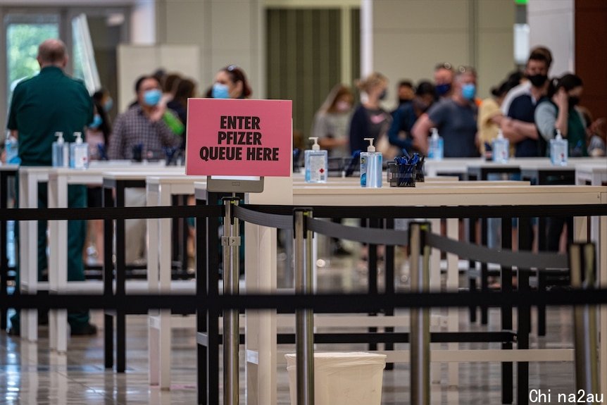 A sign showing where to queue for a Pfizer vaccination