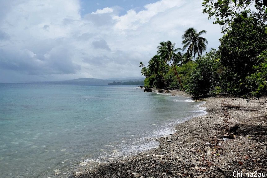 Clear blue waters and cloudy skies above the shoreline of Bonege Beach.