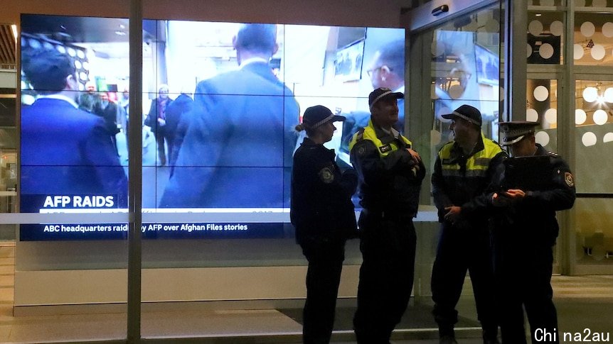 Police officers stand outside the ABC's Ultimo headquarters