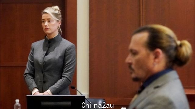 Johnny Depp looks on as Amber Heard takes the stand