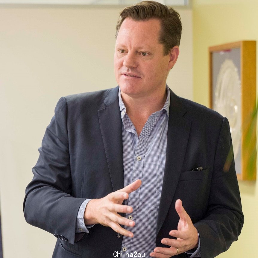 A man in a suit talking.