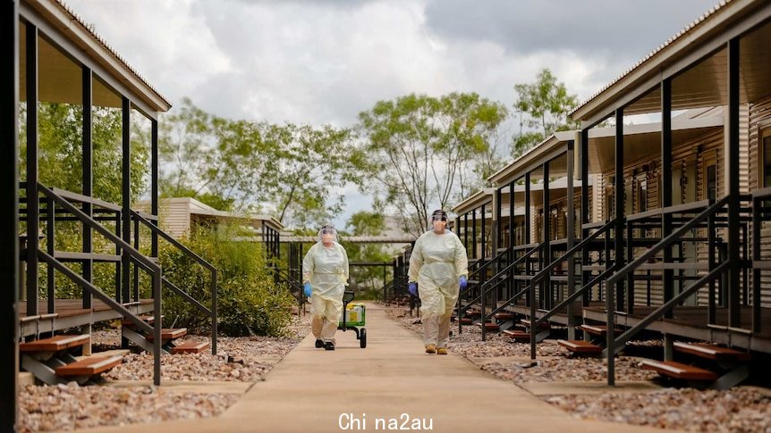 Specialist staff at the Howard Springs facility wear heavy PPE gear.