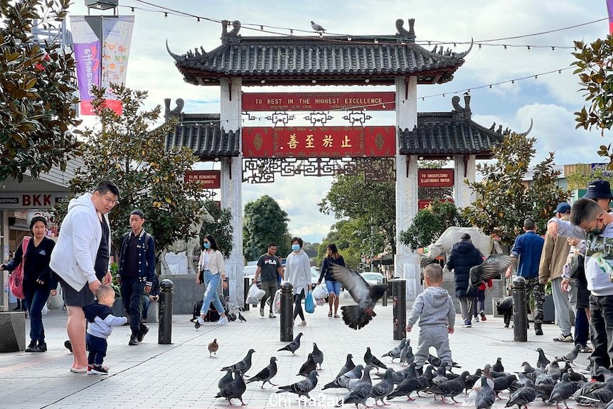 People walk down a street.