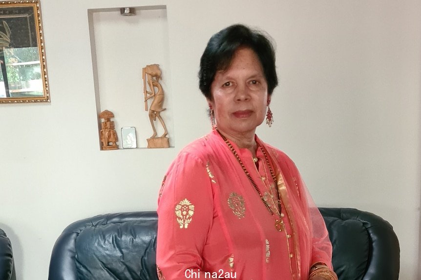 Indira Mohan in tradational Indian dress poses in her loungeroom. 