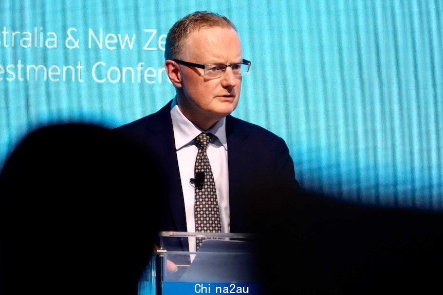 A man at a podium in a suit.