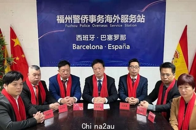 A photo of Chinese people sitting in front of a banner