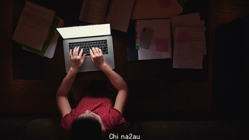 Woman working from home late at night - stock photo