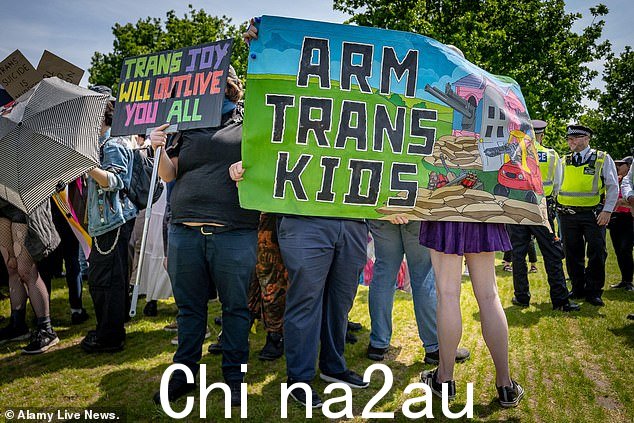 一些跨性别权利示威者被拍到举着写着“Arm trans kids”的横幅