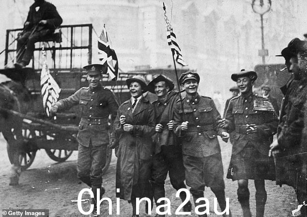 1918 年 11 月 11 日停战日，一群士兵沿着海滩奔跑，其中包括一名苏格兰人、一名澳大利亚人和一名女子陆军辅助部队成员